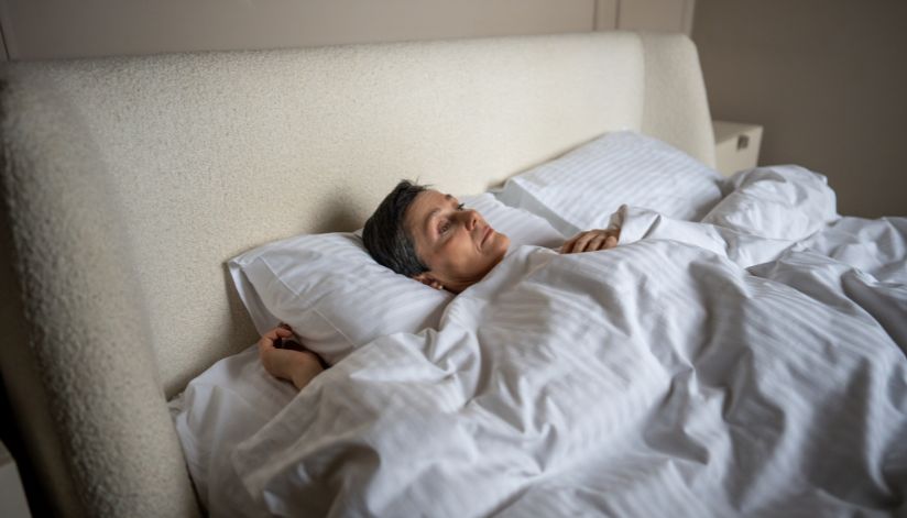 relevate-ketafusion-understanding-dissociation-woman-laying-in-bed-staring-off-824x471