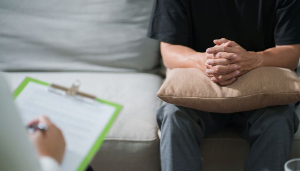 relevate-ketafusion-why-ketamine-is-being-studied-for-PTSD-and-trauma-patient-sitting-therapy-checkup-824x471